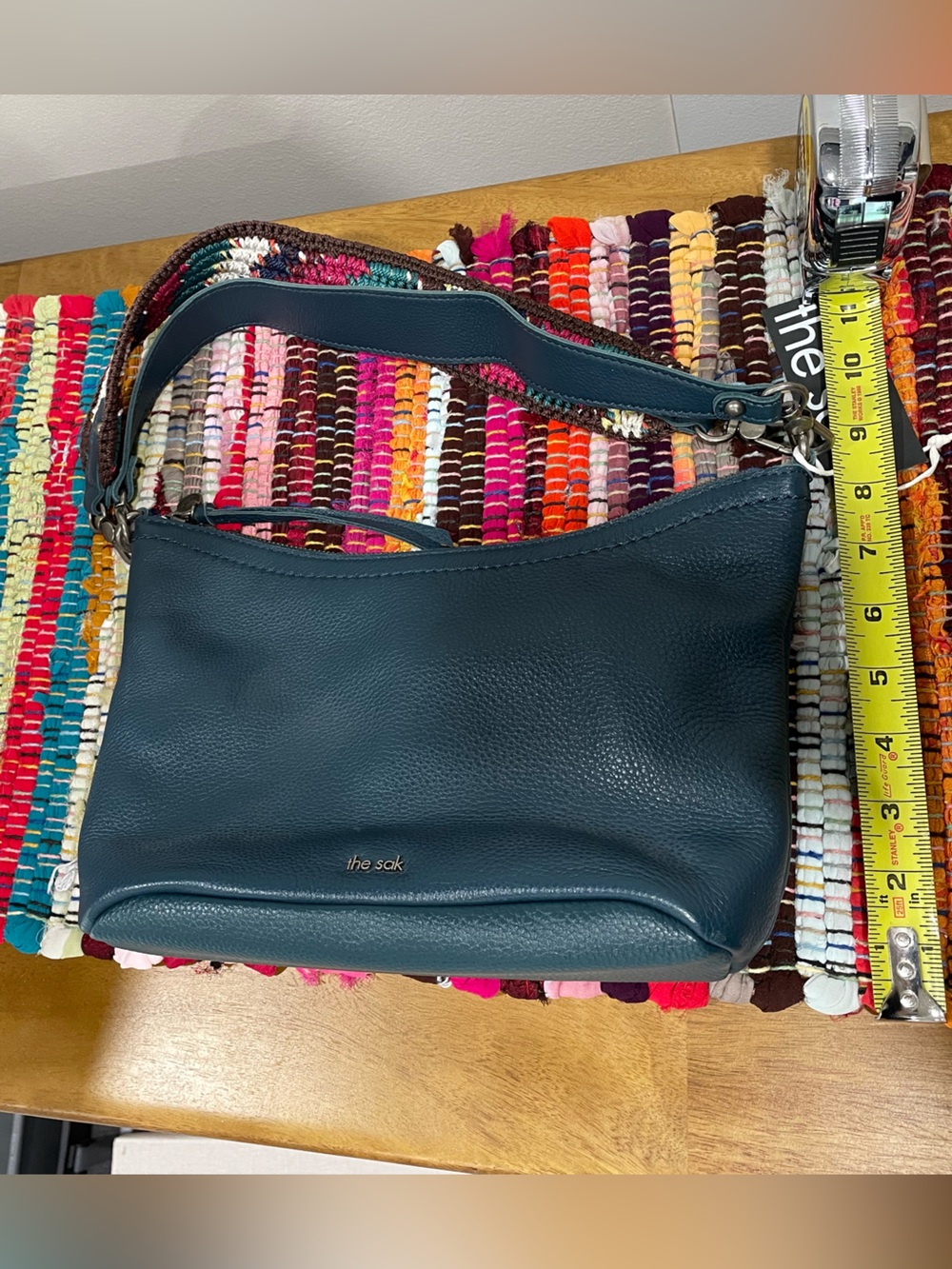 The Sak Teal Pebbled Leather Shoulder Bag with Multicolor Woven Strap